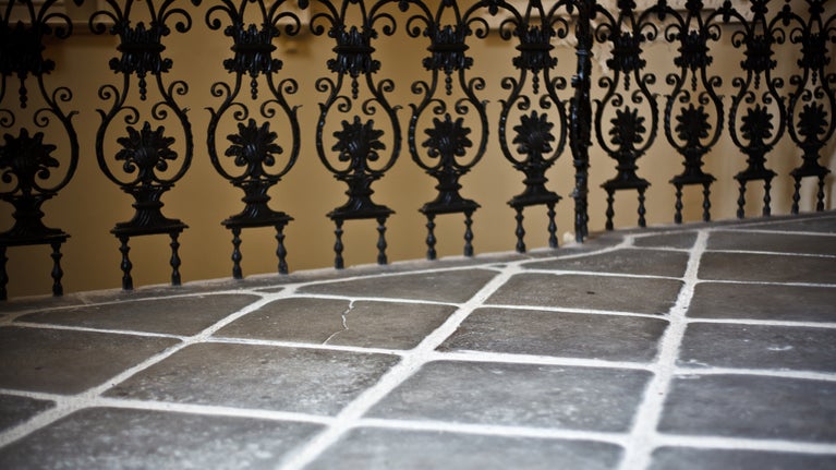 Details of a decorative balustrade and slate floor